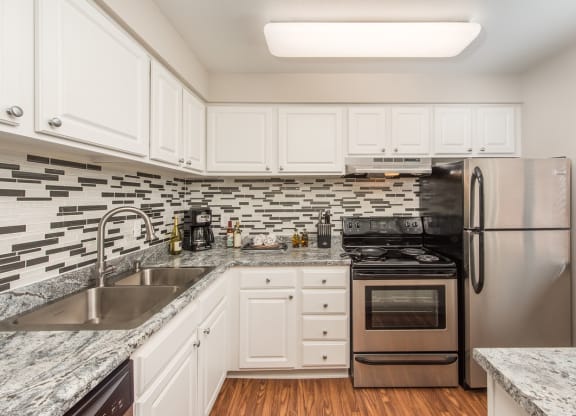 kitchen with white cabinets  at Lodge of Overland Park Apartments, Overland Park