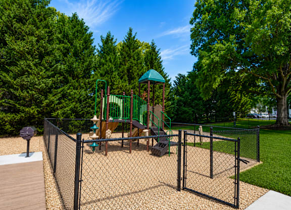 A playground with a swing set and a green dome-shaped structure.