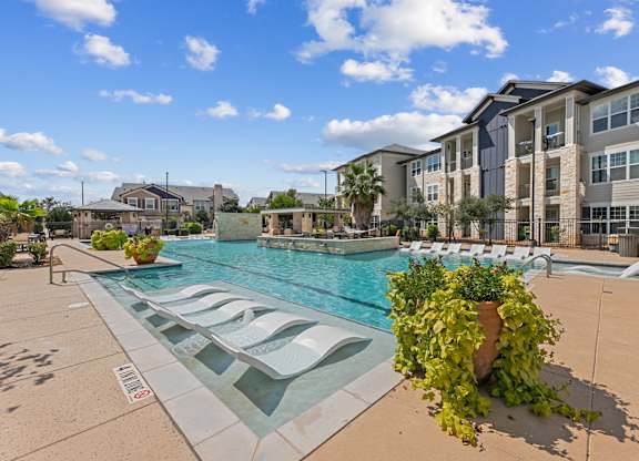 Pool Surrounded by Chairs at Citadel at Westpointe Apartments, San Antonio