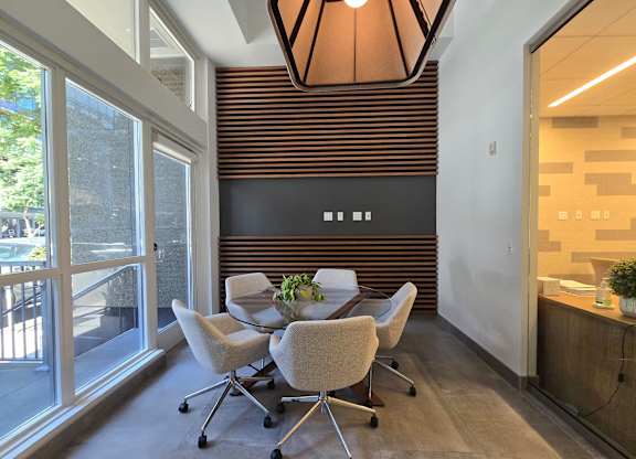 A conference room with a table and chairs.