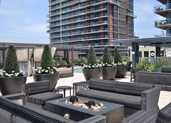 A patio with a fire pit and seating area.