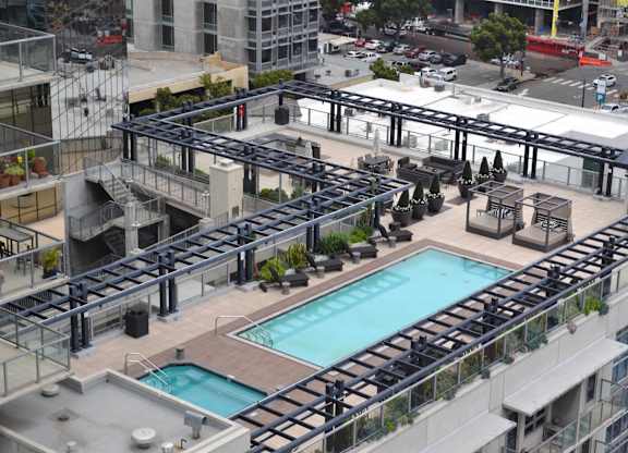 A large pool surrounded by balconies and railings.