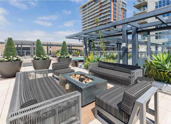 A patio with a table and chairs and a building in the background.