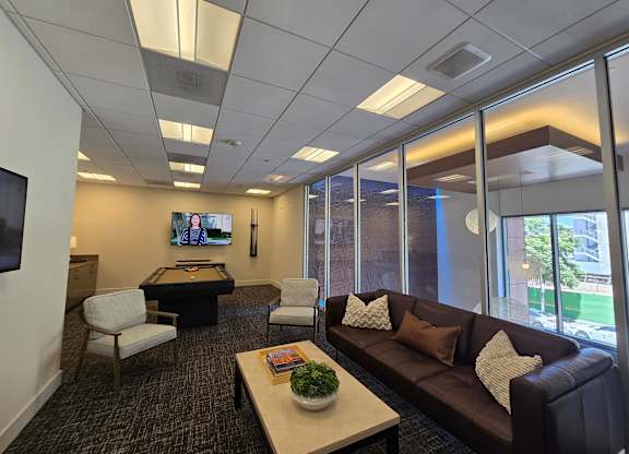 A conference room with a flat screen TV mounted on the wall.