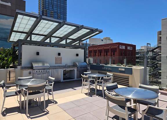 A rooftop patio with a table and chairs.