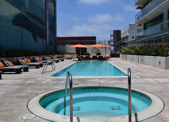 A round swimming pool with a metal ladder in the middle.