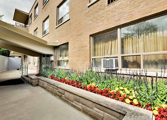 the preserve at cardinal heights apartment building entrance and patio with flowers