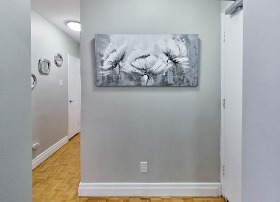 the living room of a house with a painting on the wall