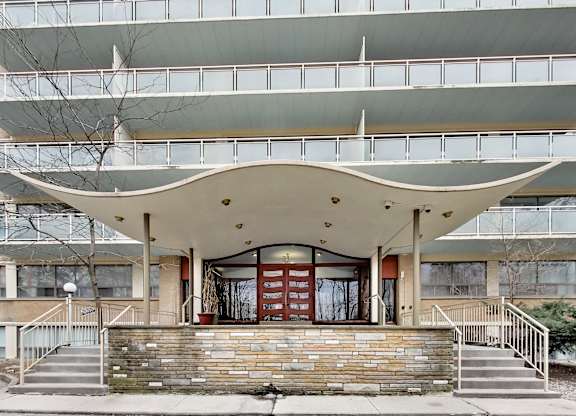A modern building with a curved overhang in front.
