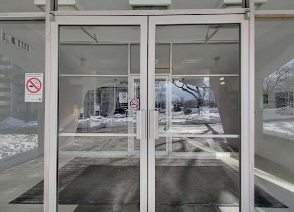 a glass door with a no smoking sign on it