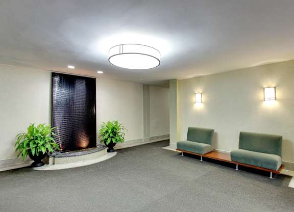 a large room with chairs and a fountain