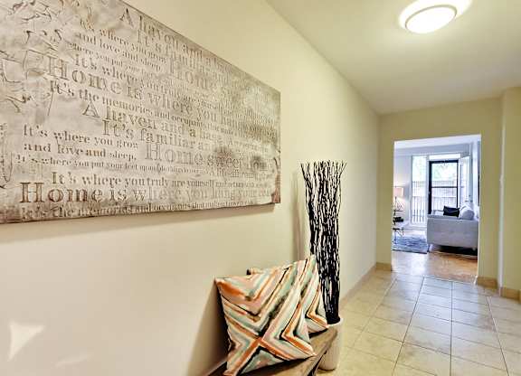 the living room of a house with a painting on the wall
