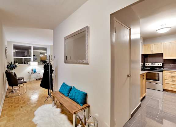 a living room with a couch and a tv and a kitchen