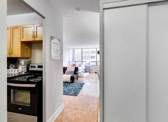 A kitchen with a stove top oven and a white door.