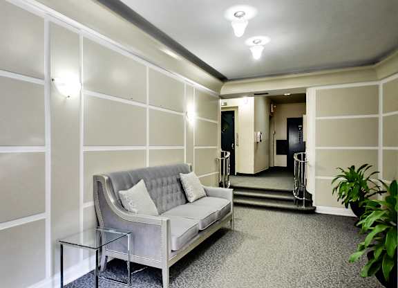 a living room with a couch and a glass table
