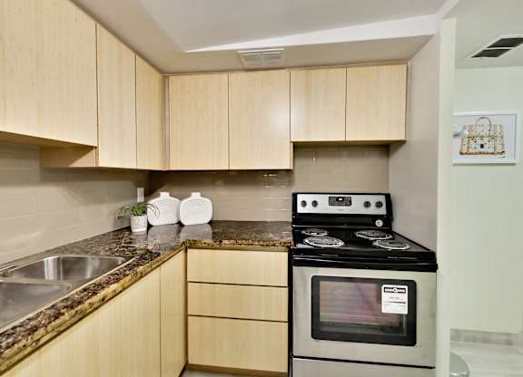 A kitchen with a stove and a counter.