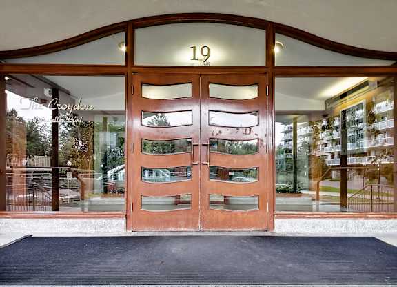The front door of a building with the number 19 on it.