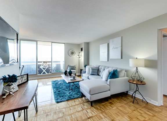 a living room with a couch and a chair and a table
