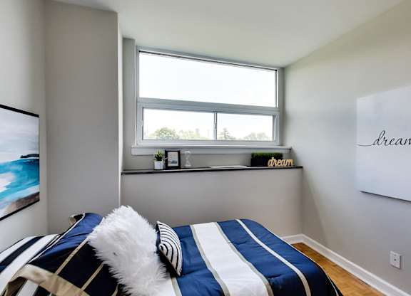 a bedroom with a bed and a window