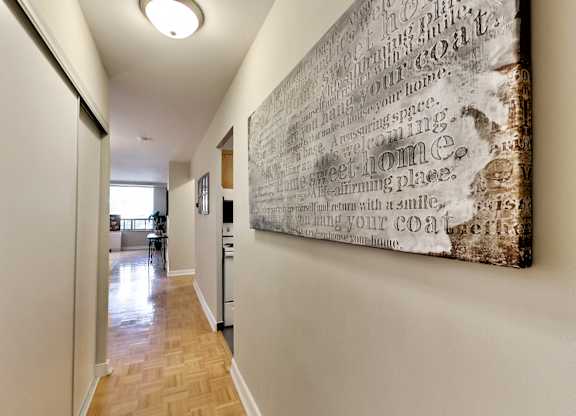 A hallway with a large piece of artwork on the wall.