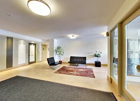 a living room with a couch and a rug