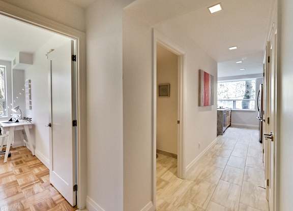 a view of the hallway from the living room into the dining room and the kitchen