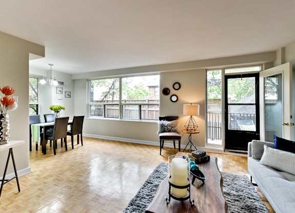 an open living room and dining room with a large window