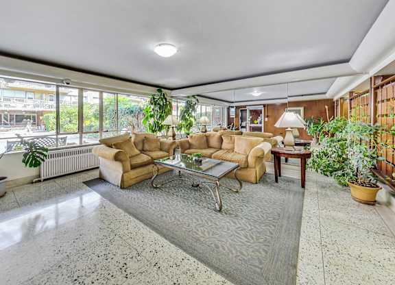 a living room with couches and a table     and a large