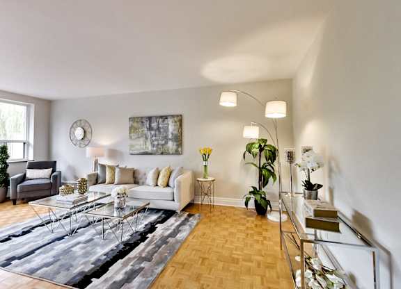 a living room with a white couch and a glass table