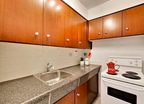 A kitchen with a white stove and a sink.