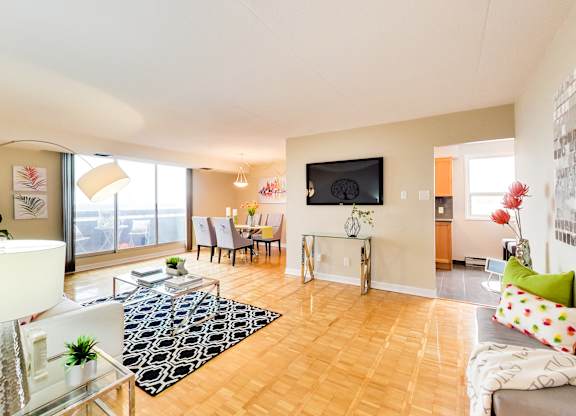 a living room with a table and chairs and a large window