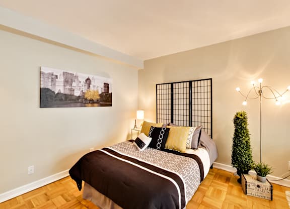 a bedroom with a bed and a painting on the wall