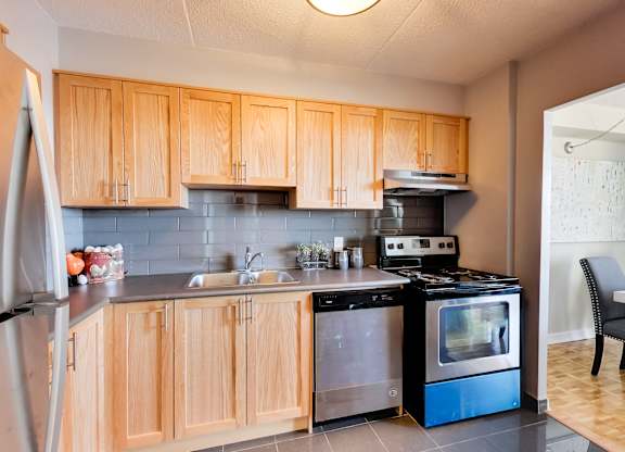 a kitchen with wooden cabinets and stainless steel appliances