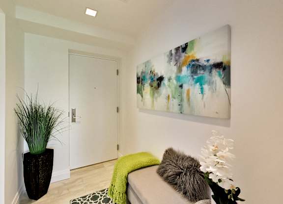 a living room with a couch and a painting on the wall