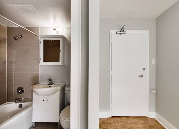 a bathroom with a sink toilet and shower and a mirror
