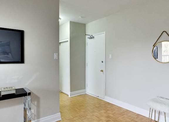 a living room with a tv and a door to a closet