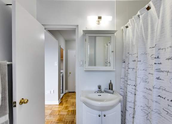 a bathroom with a sink and a shower curtain