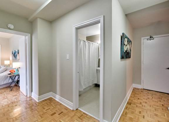 a renovated living room with a sliding glass door to a bathroom and a bedroom with