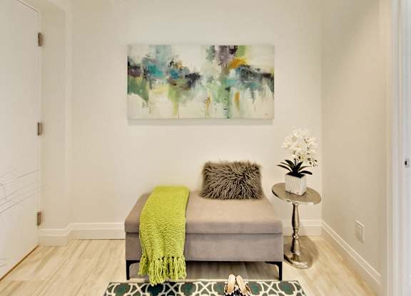 a living room with a couch and a painting on the wall