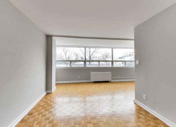 an empty living room with a large window