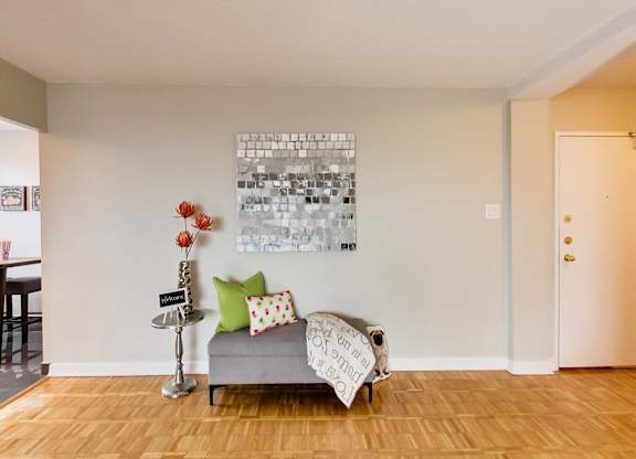 a living room with a couch and a painting on the wall