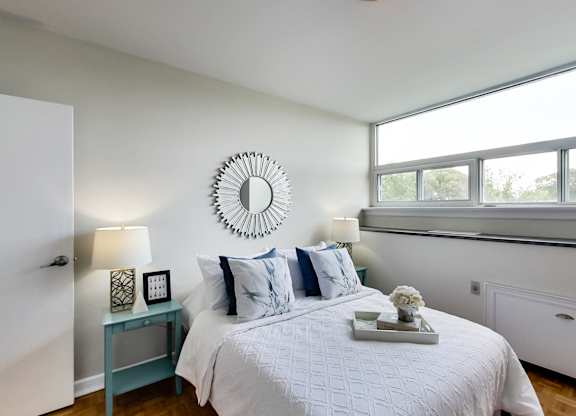 a bedroom with a large bed and a mirror on the wall
