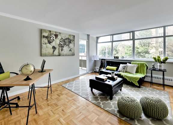 A living room with a green couch and a wooden table.