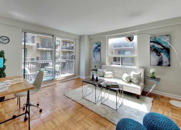 a living room with a couch and a table and a balcony