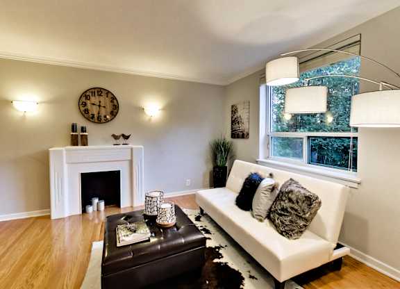 a living room with a white couch and a fireplace