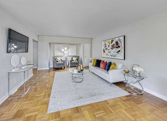 a living room with a couch and a rug and a tv