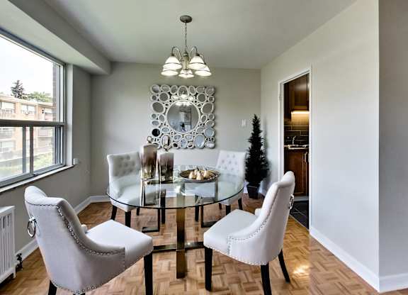 an image of a dining room with a glass table and chairs