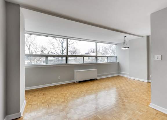an empty living room with a large window
