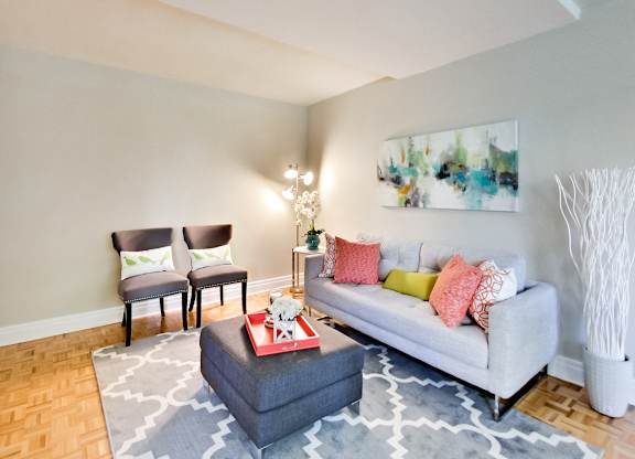 a living room with a couch and two chairs