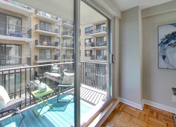 a balcony with patio furniture and a sliding glass door